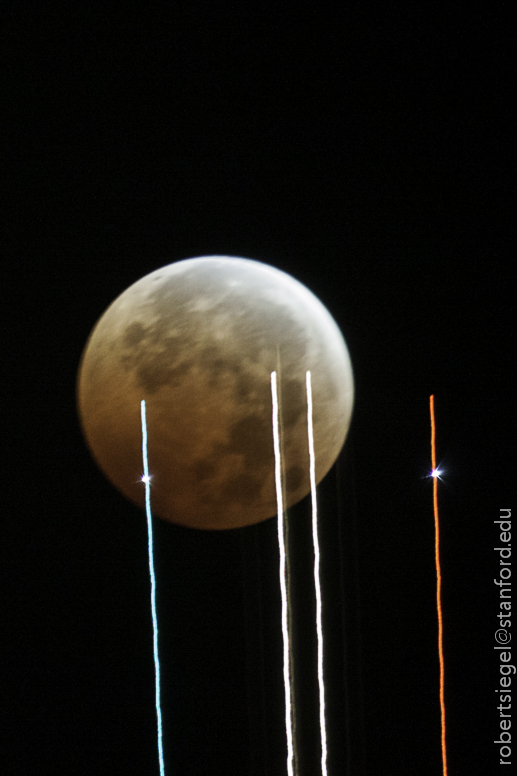 jet in front of lunar eclipse